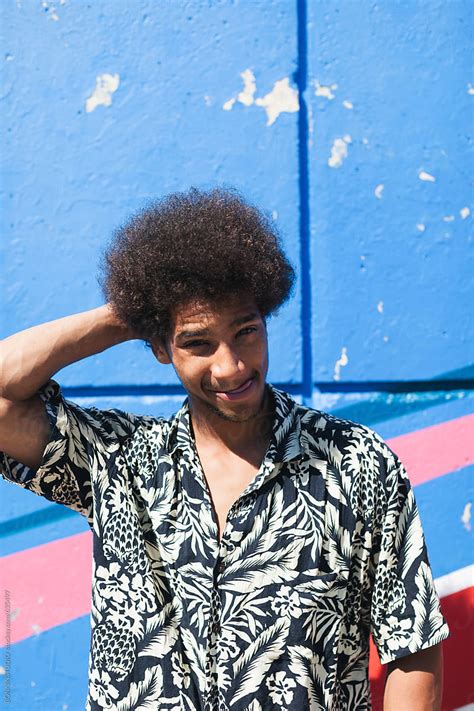 «portrait Of A Young Afro Man Standing In Front Of A Colourful Wall