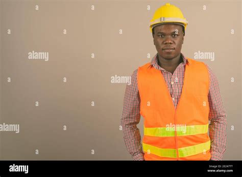 Young African Man Construction Worker Against White Background Stock