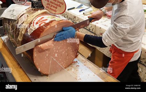 Giant Italian Mortadella Artisan Slices With Huge Knife Stock Photo