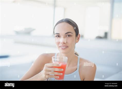 Portrait Confident Brunette Woman Drinking Juice Stock Photo Alamy