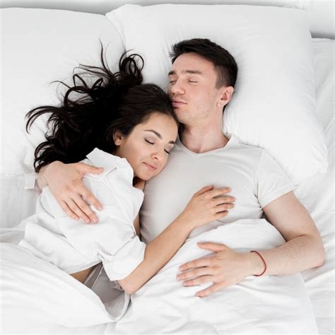 Premium Photo Enamored Young Couple Sleeping In Bed Together