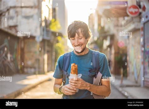 Man eating street food in Istanbul. Balik ekmek - fish in a bread ...
