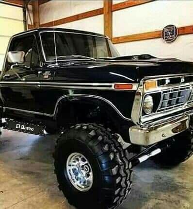 A Large Black Truck Parked In A Garage