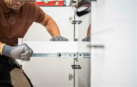 Handyman Installing Pull-Out Kitchen Shelves 24524021 Stock Photo at Vecteezy