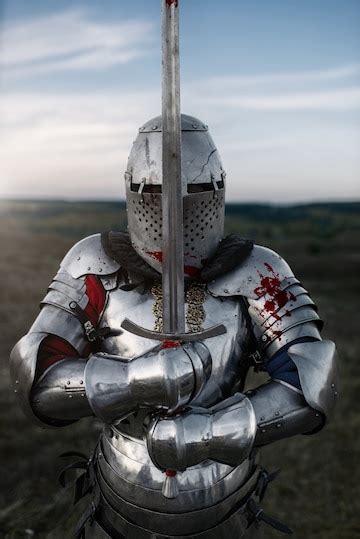 Premium Photo Medieval Knight In Armor And Helmet Poses With Sword