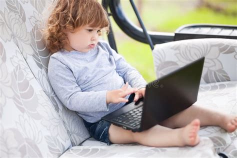 Smart Toddler Girl Using Laptop Computer Child And Technology Stock