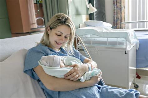 Mother With Her Newborn Baby At The Hospital A Day After A Natural