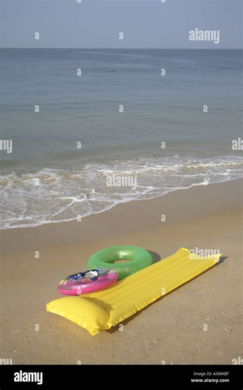 Plastic floaters and bed on beach Stock Photo - Alamy