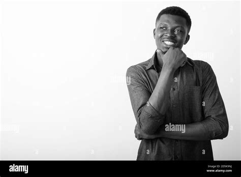 Studio Shot Of Young Happy Black African Man Smiling While Thinking