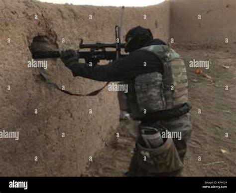 An Afghan Commando Sniper Searches For Enemy During An Offensive