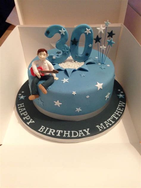 A Blue Birthday Cake With The Number Twenty Five On It And A Woman