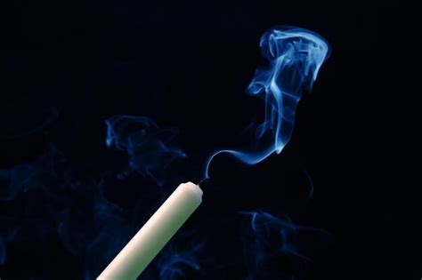 Premium Photo Smoke From An Extinguished Candle On A Dark Background