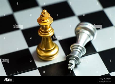 Top View Of Gold King Chess Piece Win Over Lying Down Silver King On