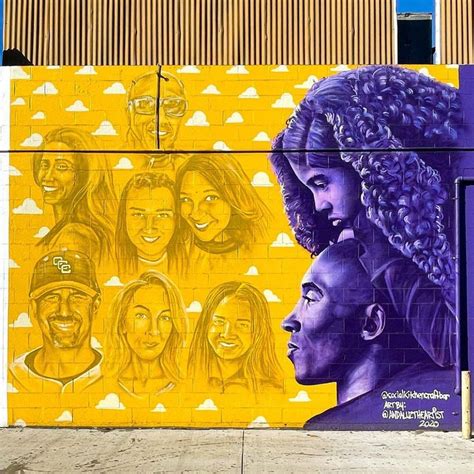 A Mural On The Side Of A Building With People S Faces Painted On It