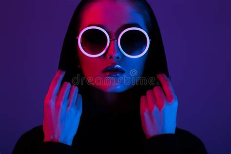 Portrait Of Fashion Girl With Stylish Makeup And Blue Neon Light On Her