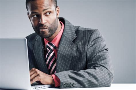 Young African American Businessman Being Sneaky On Laptop Stock Image