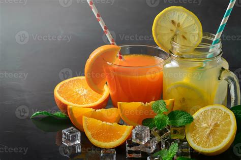 Orange juice and lemon juice on black stone 23313240 Stock Photo at ...