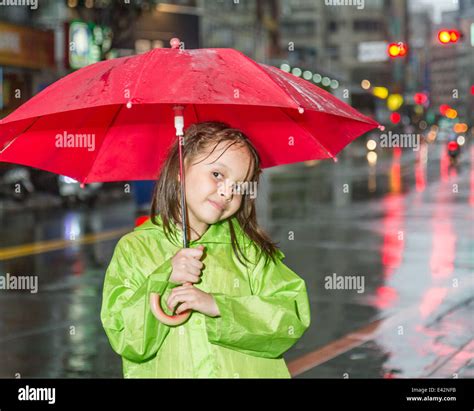 Girl Wearing Raincoat Holding Umbrella Hi Res Stock Photography And