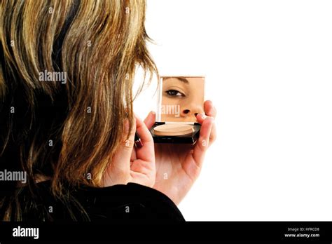 Young Woman Looking Into Compact Mirror Stock Photo Alamy