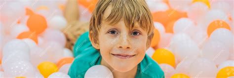 Premium Photo | Child playing in ball pit colorful toys for kids ...