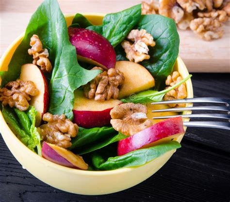 Spinach Salad with Nuts and Apples Served on Table Stock Image - Image ...