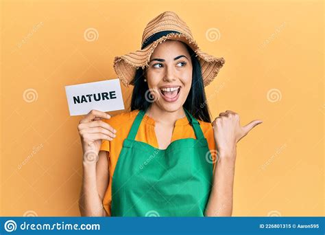 Beautiful Young Woman Wearing Gardener Apron Holding Nature Word