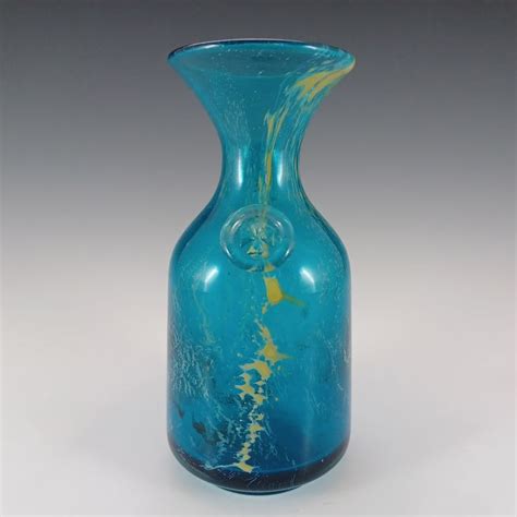 A Blue Glass Vase Sitting On Top Of A Table