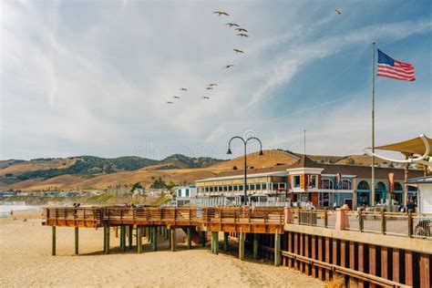 Wooden Boardwalk Along The Shore Wide Sandy Beach And Plaza In