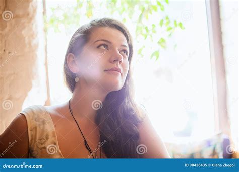 Lifestyle Portrait Of Brunette Girl In Cafe Holding Class Of Cocktail