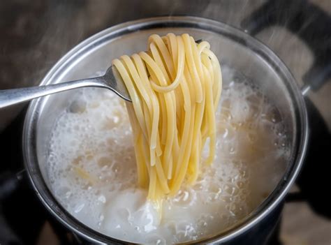 Premium Photo Yellow Noodles Or Spaghetti Cooking In Boiling Water Pot