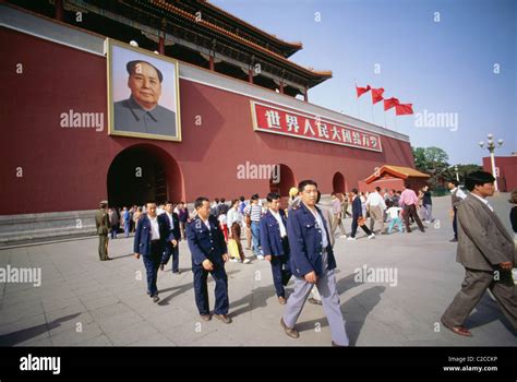 People Walking Under Gate Of Heavenly Peace With Portrait Of Mao Zedong