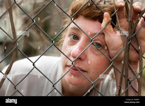 Woman Behind Fence Stock Photo Alamy