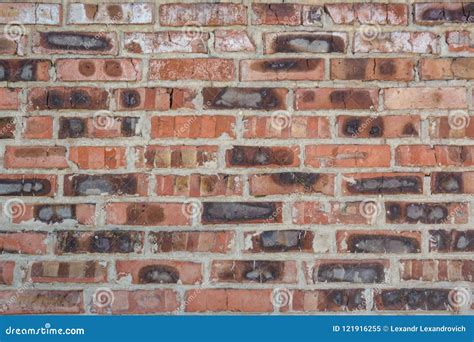 Red Faded Burned Old Bricks Background With Flaws And Splits Stock