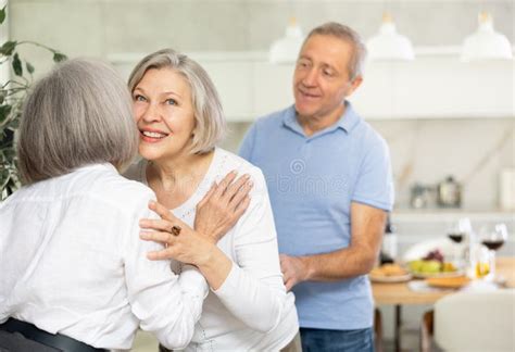 After Chatting And Gatherings Two Mature Women Friends Hug And Kiss