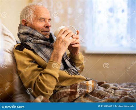 Gray Haired Elderly Man Is Sick And Drinking Hot Tea At Home Stock Photo Image Of Home