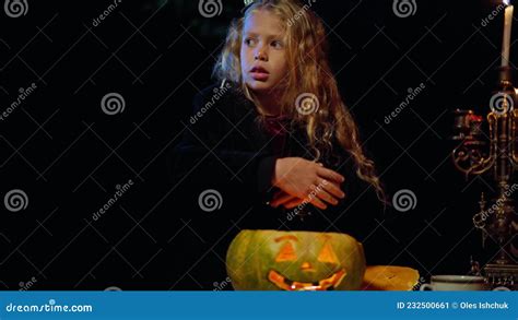 Frightened Caucasian Girl On Halloween Night In Scary Forest With