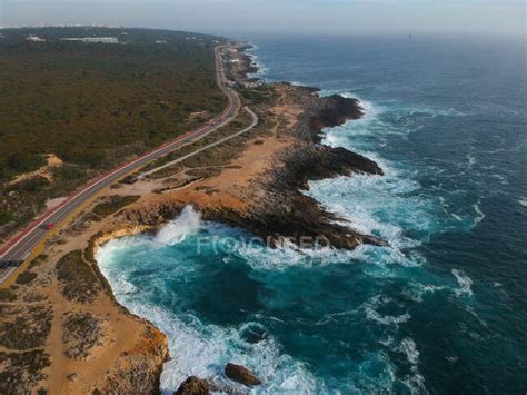 Aerial Top View Of Sea Waves Hitting Rocks On The Beach Coast Stone