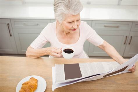 Premium Photo Senior Woman Reading A Newspaper At Home