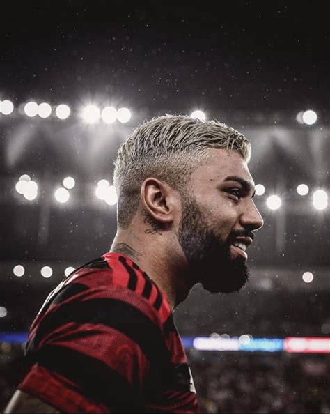 A Man With A Beard Standing In Front Of A Stadium