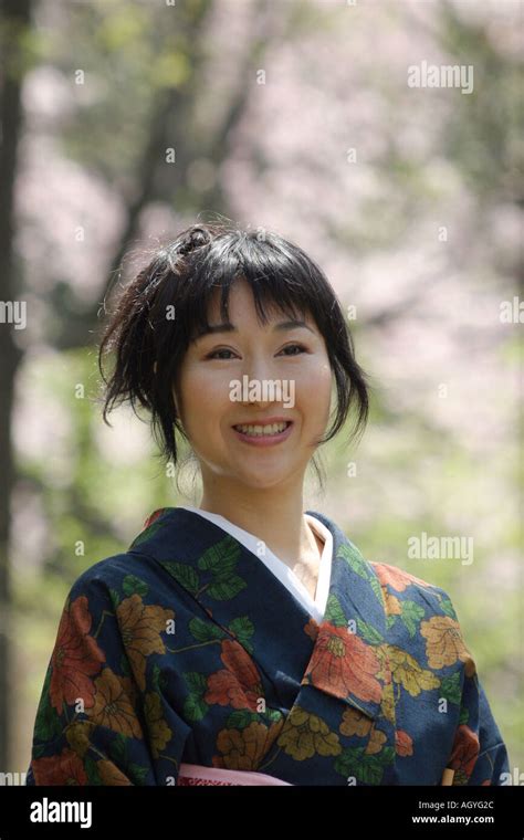 Portrait Of A Japanese Woman Wearing Kimono Cherry Blossom Background