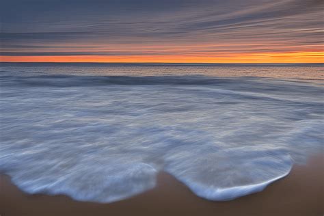 Sunrise over a New England Beach · Creative Fabrica