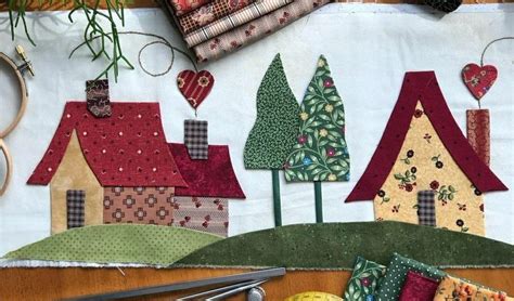 A Table Topped With Lots Of Different Types Of Quilts And Sewing