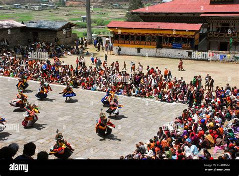 Performers In Costume Do A Cham Dance At The Bhutanese Paro Tshechu