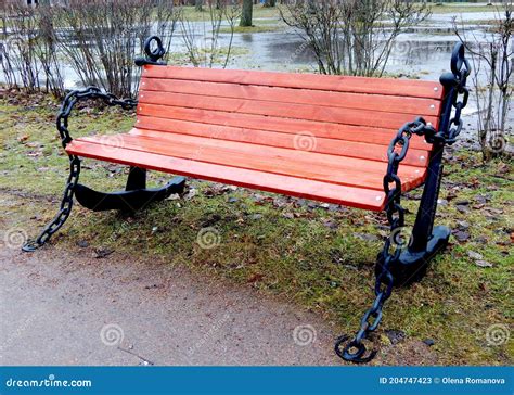 Wooden Brown Bench With Iron Anchors On The Sides In The Park Stock