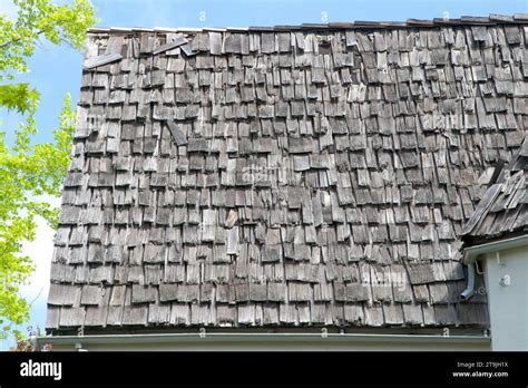 Wood shingle roof in poor repair. Wood shingles are thin, tapered pieces of wood primarily used ...