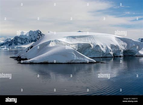 smooth snow cover on islands of paradise harbour (bay) with traces of ...