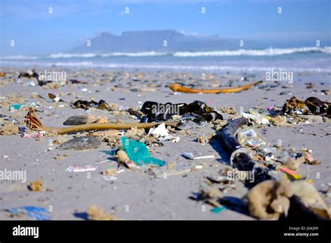 Cape Town,South Africa. Plastic Pollution on Cape beaches with Table Mountain in the background ...