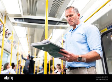 Mature Businessman Reading Newspaper On Train Stock Photo Alamy