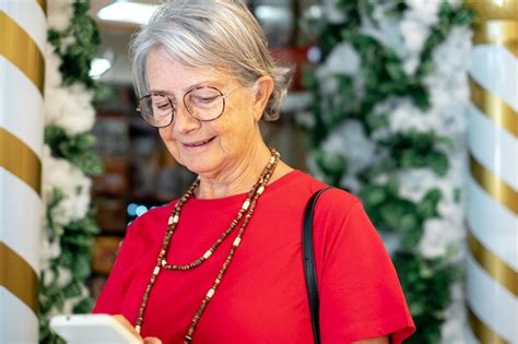 Premium Photo Smiling Mature Lady As She Walks Out Of A Christmas