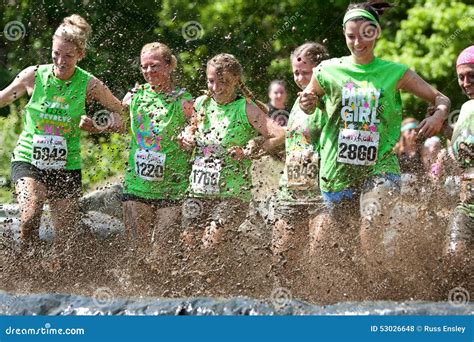 Women In Mud Pit On Obstacle Course Editorial Image | CartoonDealer.com #25458218